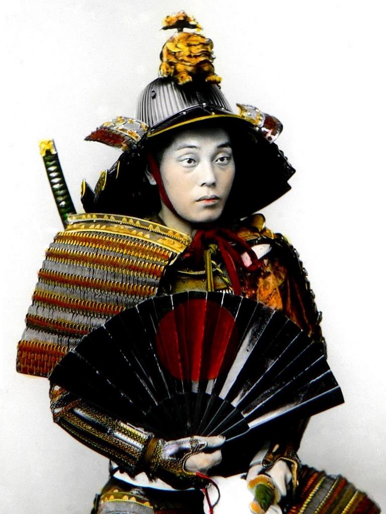 Japan warrior in full armor. Samurai with sword, helmet and fan
