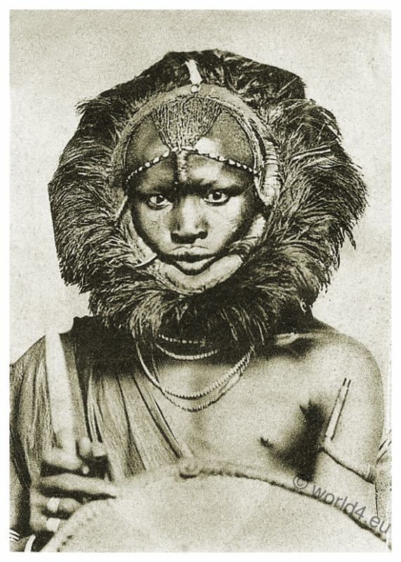 Masai warrior with spear, shield and lion headdress.