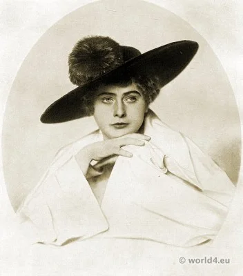 Blue velvet hat with orange colored feathers. Autumn hat fashion 1915.