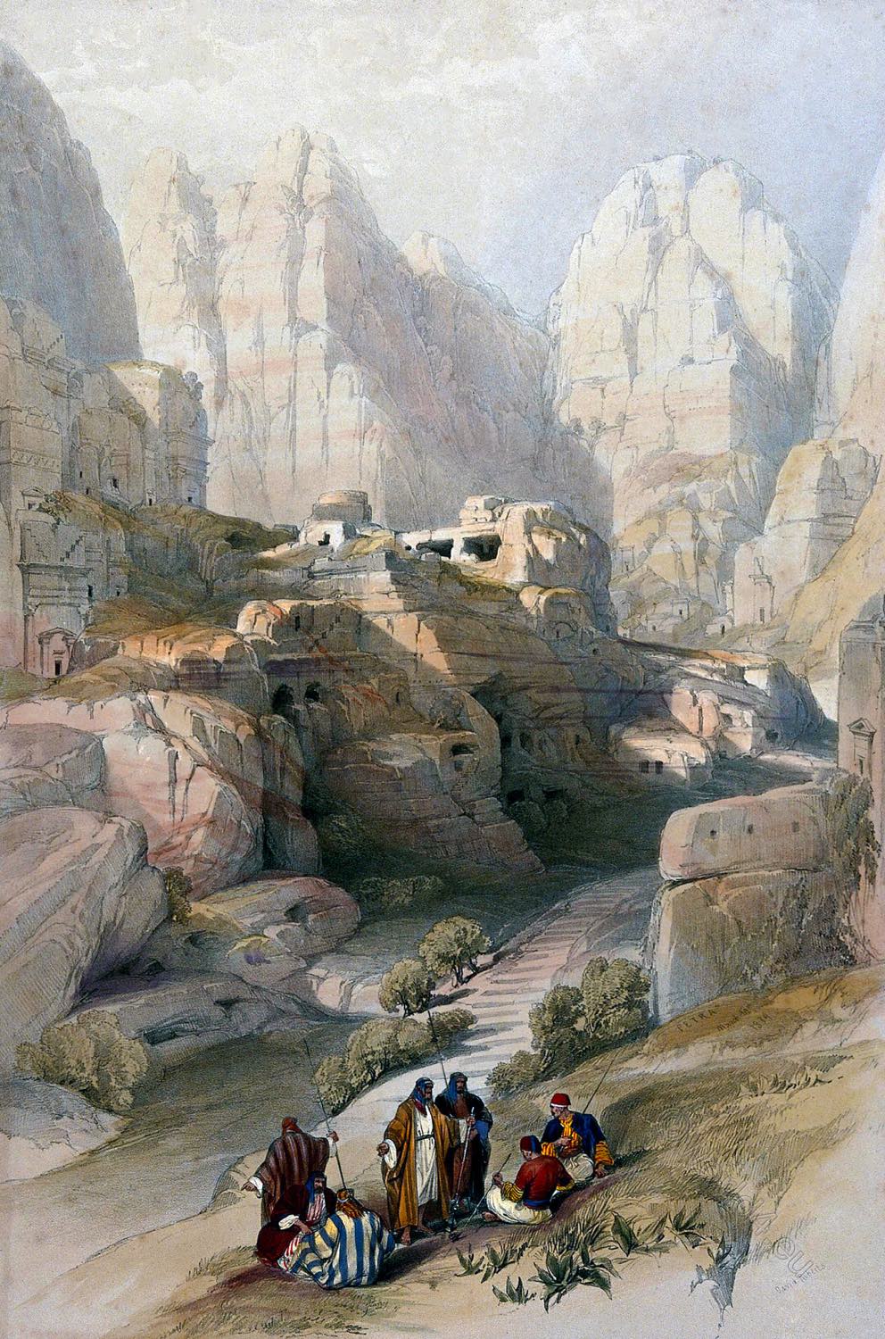Men sitting to smoke by a ravine at Petra, Jordan.